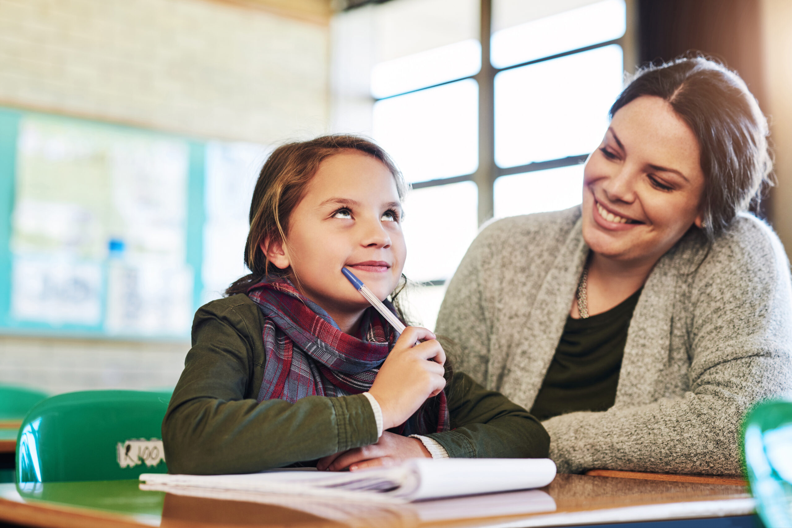 An adult listening to a child during a learning activity.