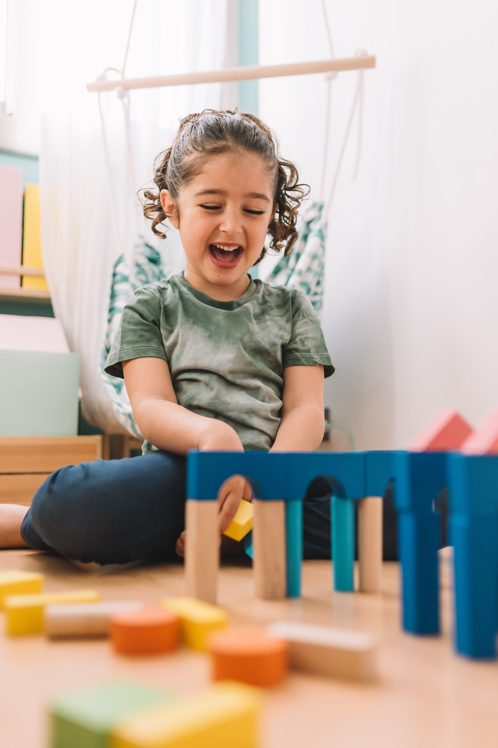A child enjoying play with colorful wooden blocks.