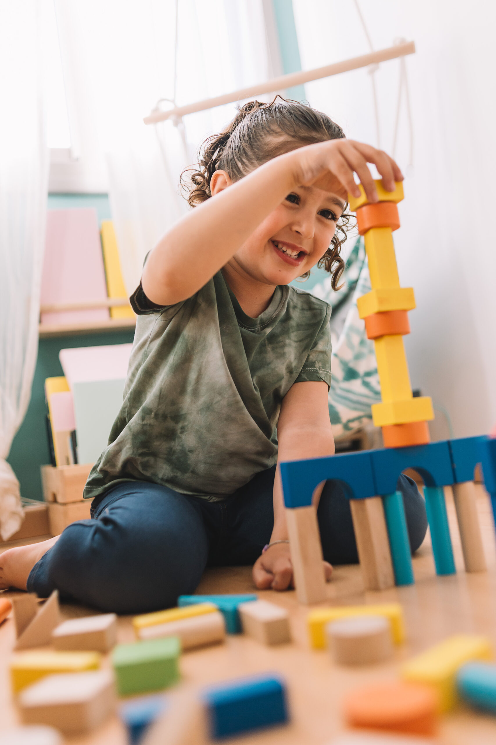 A child building a tower with colorful blocks.