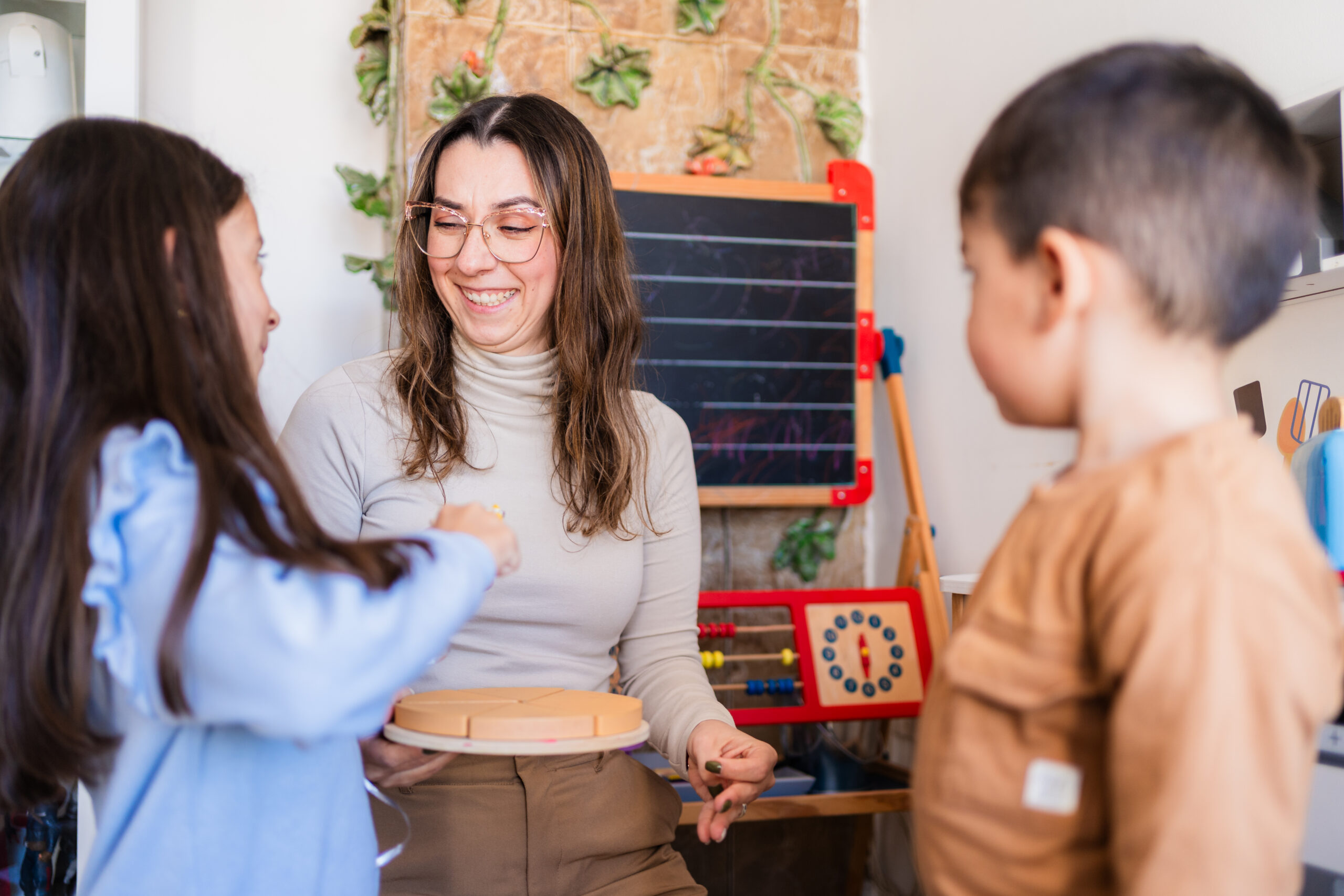 An adult and children exploring a learning activity.